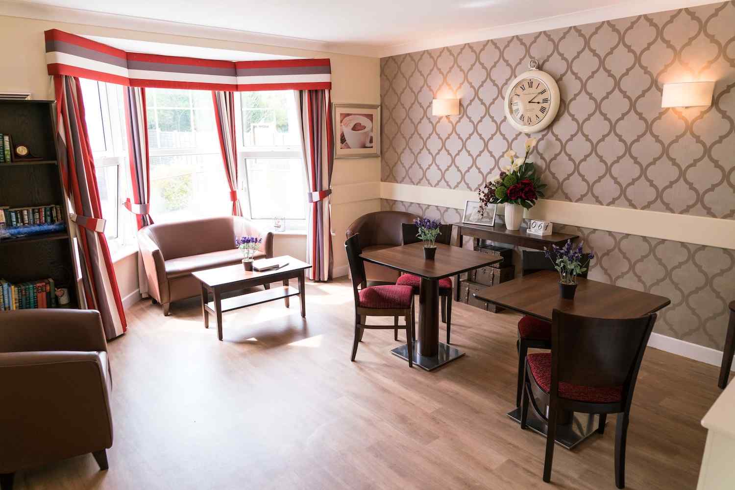 our dining room setup with brown chairs and a sofa in the corner by the window